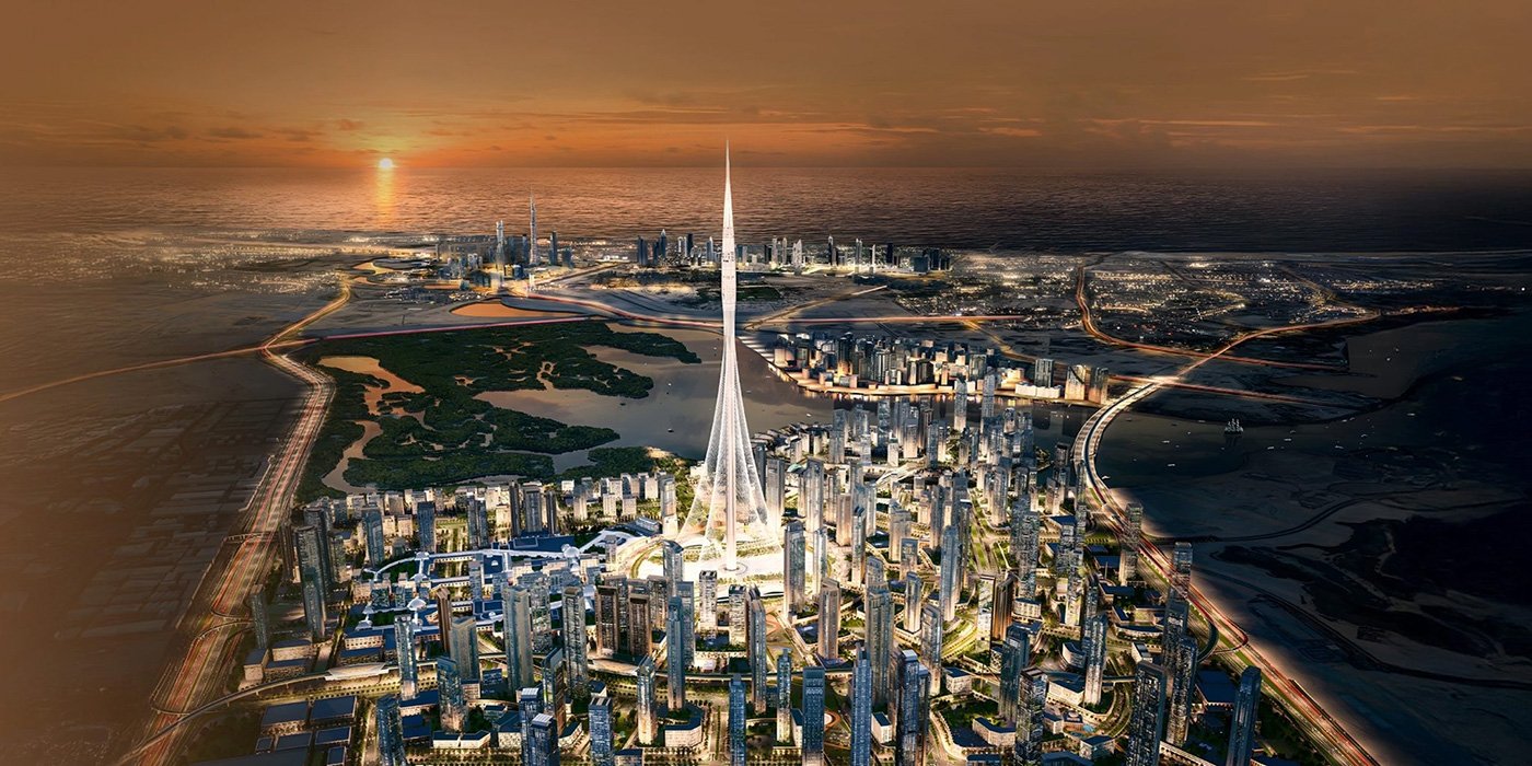 Aerial view of the Dubai Creek Harbour masterplan at sunset with Dubai Creek Tower at its centre